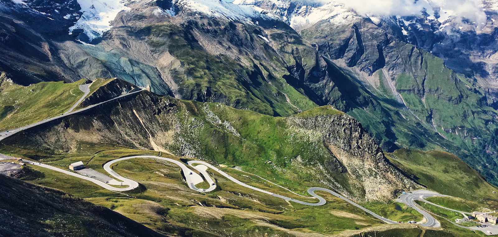 Hairpin bends of the Grossglockner High Alpine Road below snow-capped peaks and a glacier