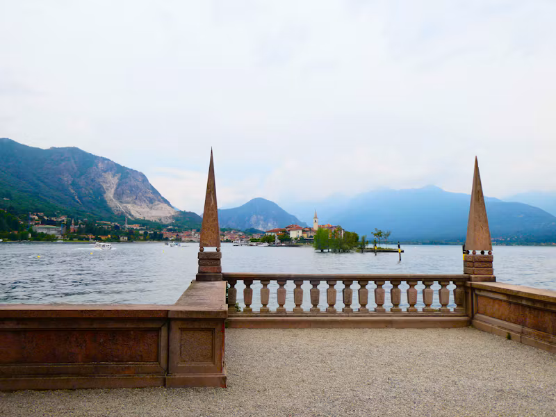 A balustrade terrace above Lake Maggiore at Baveno, with mountains behind