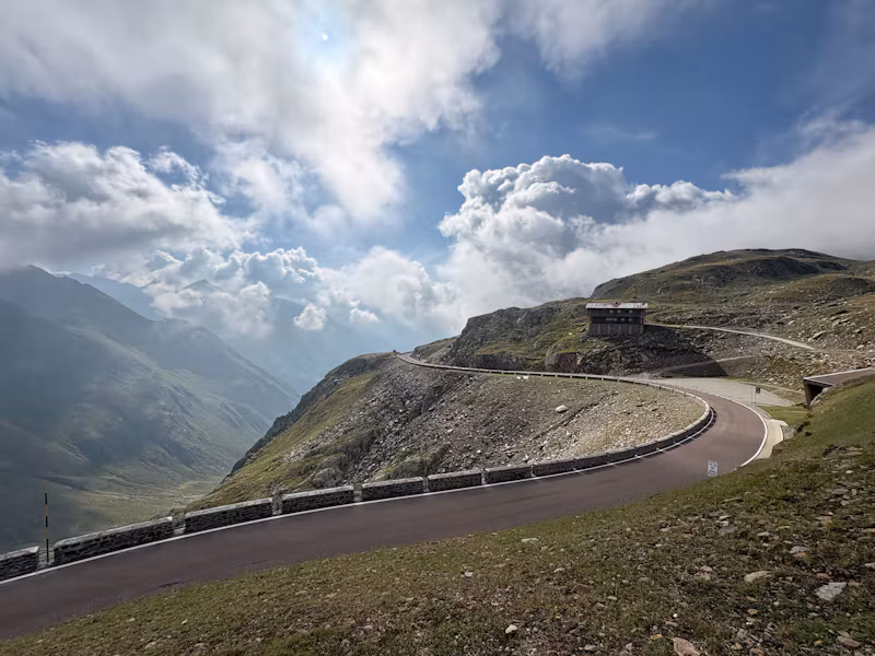 The road curving over the Timmelsjoch pass under cloud